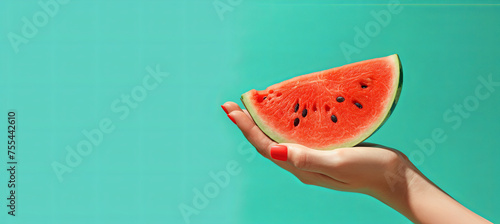 Woman holds slised watermelon, summer concept, green background photo
