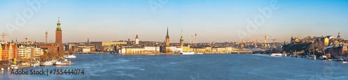 Panorama of Stockholm old town, kungsholmen and Södermalm district with the Lake Malären in front view. Clear winter sky, colorful buildings, churches and cathedrals and the Stockholm town hall.