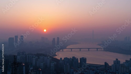 Sunrise of city buildings along the Han River seen from Maebongsan Park at dawn in Seoul, South Korea photo