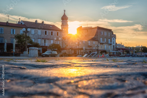 Scenic view of Krk, the town on the Krk island, Kvarner bay, Croatia. Beautiful cityscape with medieval architecture, harbor with yachts and rising sun, Adriatic seacoast, outdoor travel background