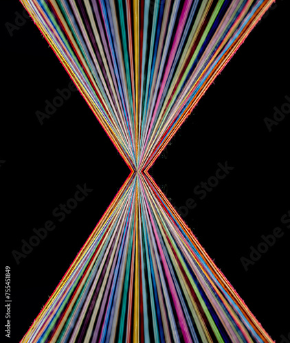 Converging Rainbow Colored Threads on dark background
