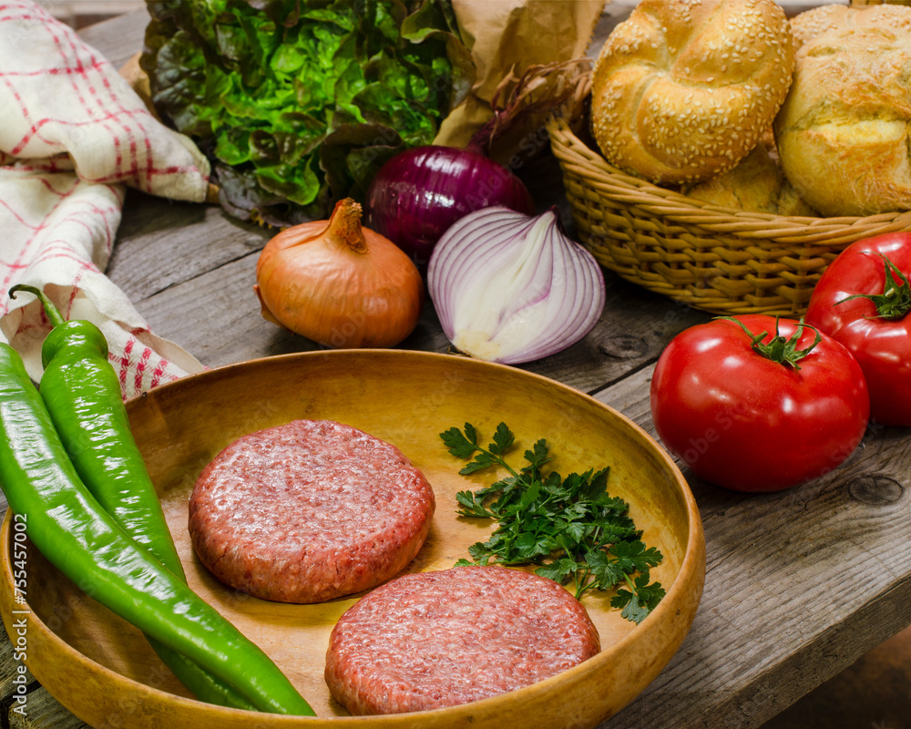 Hamburger in preparation, rustic scene at home, still life, food photography Hamburger in preparation, rustic scene at home, still life, food photography