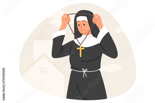 Woman nun in religious cassock wears necklace with christian cross going to worship in church. Young girl nun working in catholic church and helping people who came to temple for blessings