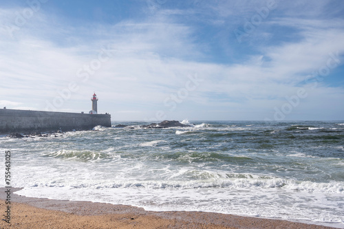 View of the historical Felgueiras Lighthouse built on 1886 in Foz do Douro near from Porto, Portugal, and the atlantic ocean on a sunny spring day