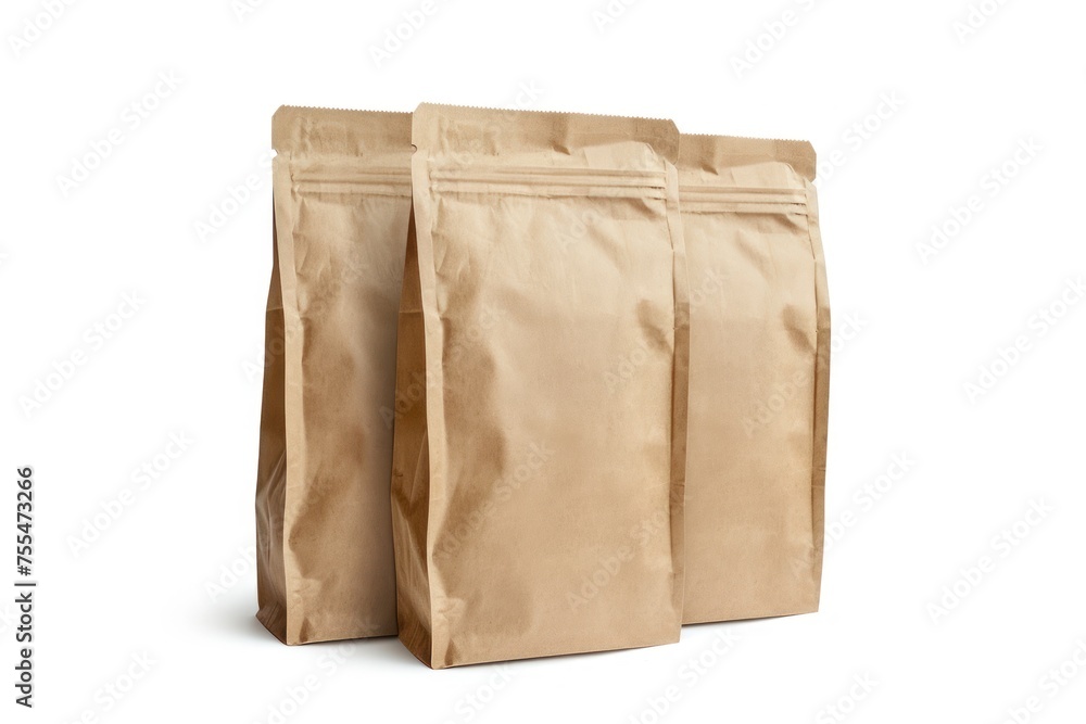 Three brown paper bags are stacked on top of each other. The bags are empty and appear to be of a similar size Three brown paper bags are stacked on top of each other. The bags are empty and appear to be of a similar size