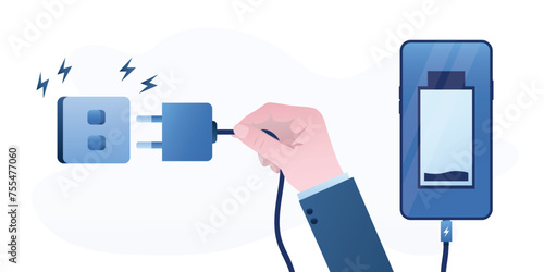 Human hand unplugging gadget and being offline. Switch off smartphone. Mobile phone with empty battery. Digital detox, concept. Disconnecting cord from socket. Health care,