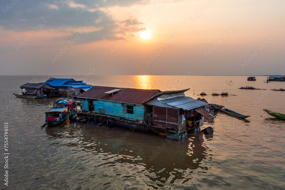 Village on the water of Tonle Sap lake in Cambodia. Beautiful lighting, sunset.