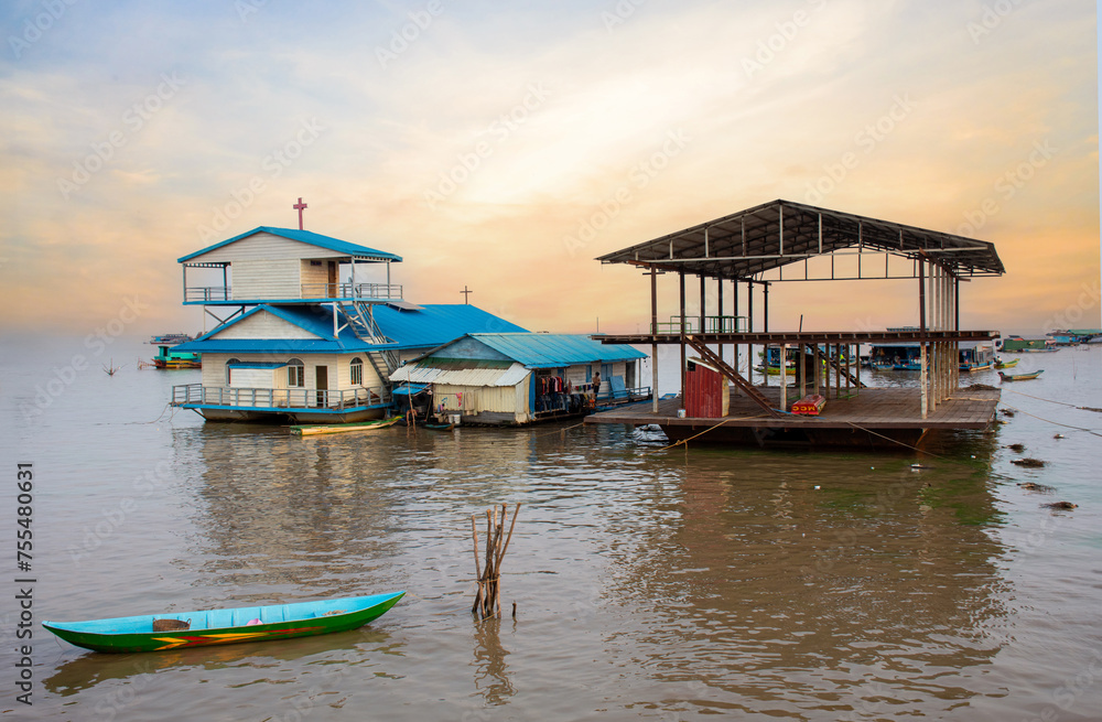 Village on the water of Tonle Sap lake in Cambodia. Beautiful lighting, sunset.