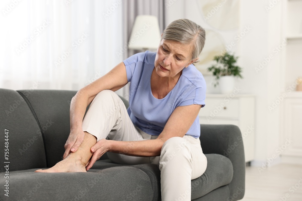 Arthritis symptoms. Woman suffering from pain in leg at home Arthritis symptoms. Woman suffering from pain in leg at home