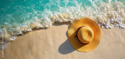 Yellow summer hat on tropical sandy beach. for mockup and advertising. Copy space. top view.