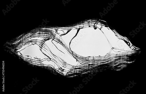 hanging teared rag spread isolated on black background , can use like a background or any texture. hole in the tissue. Unbleached beige fabric with torn stitch, hole and loose threads