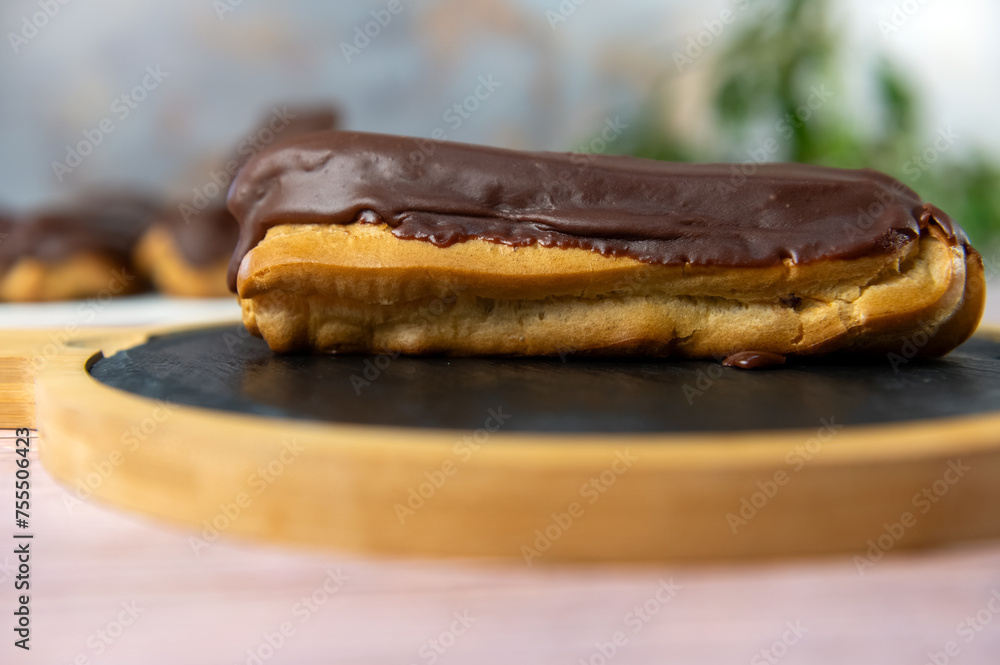 French ecler with chocolate. Traditional french dessert eclair.