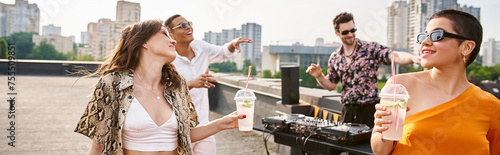 jolly diverse friends with sunglasses drinking at rooftop party and dancing to DJ set, banner