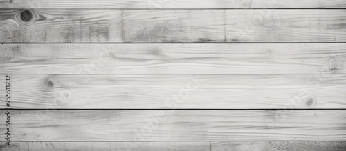 A close-up view of weathered and textured black and white wood planks arranged horizontally. The planks show signs of wear and tear, with visible knots and grains.