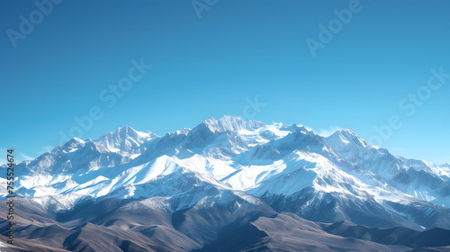 Snow-capped mountain ranges against a clear blue sky background