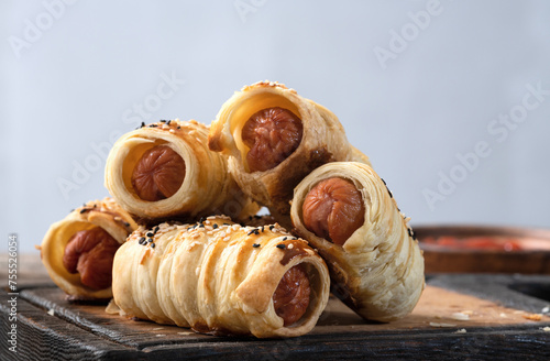 Homemade Sausage in dough rolls on plate