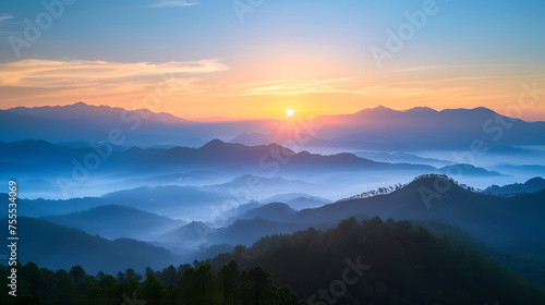 serene sunrise over a misty mountain range © SS Digital
