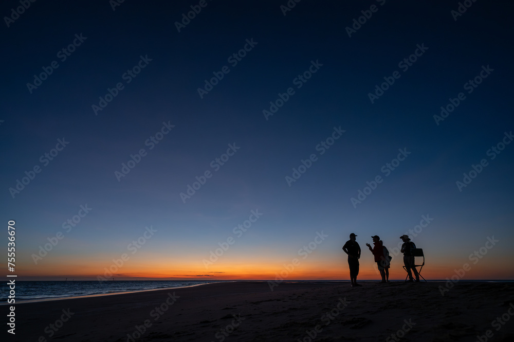 People at sunnset on a sandbar in Gulf of Carpentari
