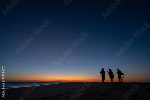People at sunnset on a sandbar in Gulf of Carpentari photo