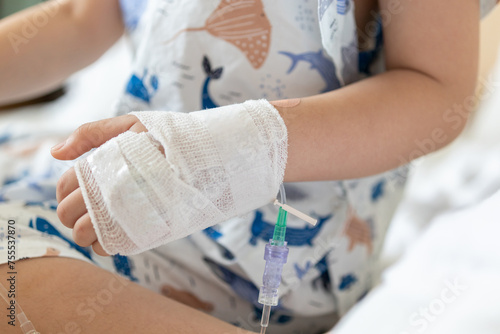 Tableau sur toile Close up child hand with saline IV solution in hospital