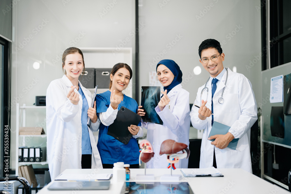 Fototapeta premium Successful team of medical doctors looking at camera and smiling while standin. Health, professional and people team in hospital