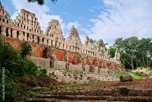 ruins of Casa de las Palomas building behind the Gran piramid in the ancient city Uxmal lost in the tropical jungle