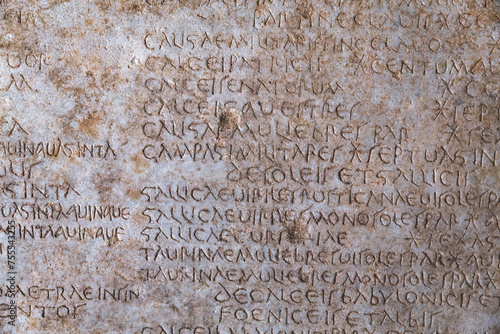 Ancient Roman script on stone, text of Diocletian's edict detailing prices in Latin language, historical artifact from 4th century. Retro text background. Kusadasi, Turkiye (Turkey)