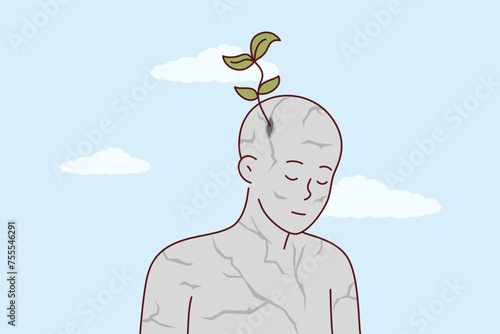 Inspired stone man with green petals growing from head as metaphor for new ideas and creative thinking. Inspired statue of man pondering environmental issues and ways to preserve environment