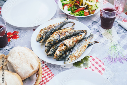 Grilled sardines, sangria, salad in Alfama, Lisbon during a festival of San Antonio in June 