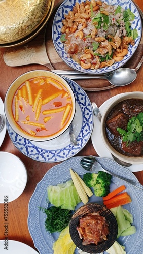 Traditional Thai southern food set. Spicy vermicelli salad, Southern styled pork stew, Southern Thai spicy sour yellow curry with lotus stems, chili shrimp paste and rice.