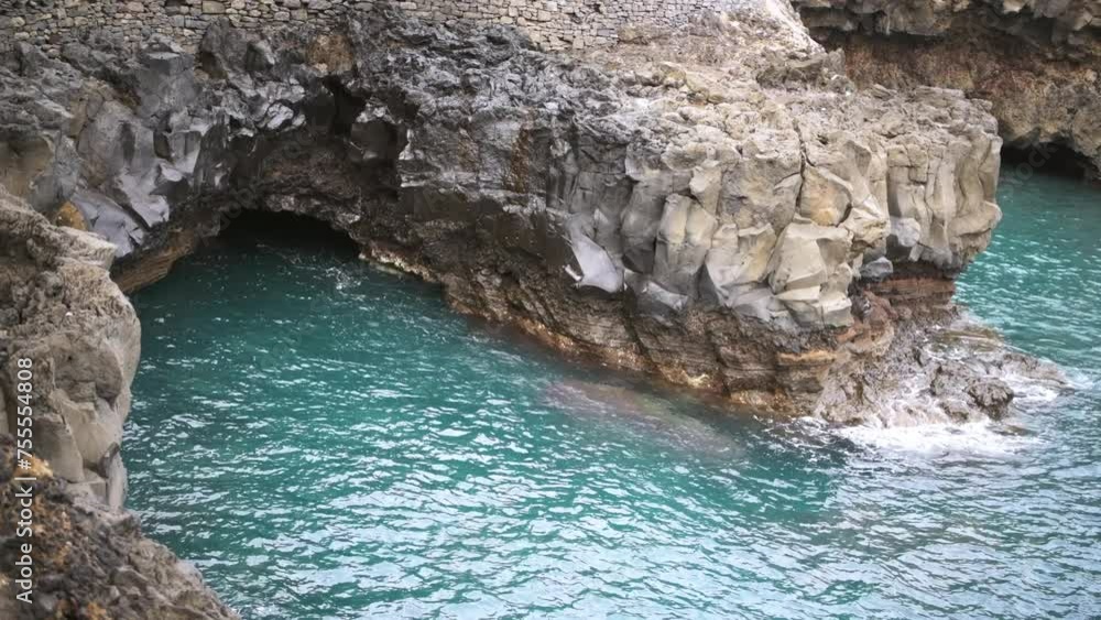Natural sea cave among the rocks on a calm day. Porto da Cruz, Madeira Natural sea cave among the rocks on a calm day. Porto da Cruz, Madeira