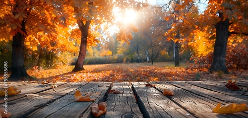 Wooden desk in a park with autumn leaves for photo product. photo