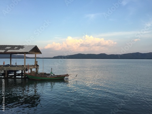 The boat is moored at the pier in the sea