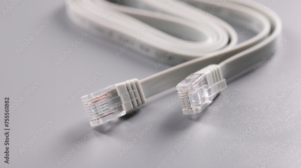 Closeup of rj45 cable on gray background. internet connection concept Closeup of rj45 cable on gray background. internet connection concept