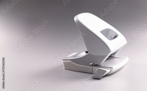Closeup of hole puncher on gray background. Document sorting accessories concept