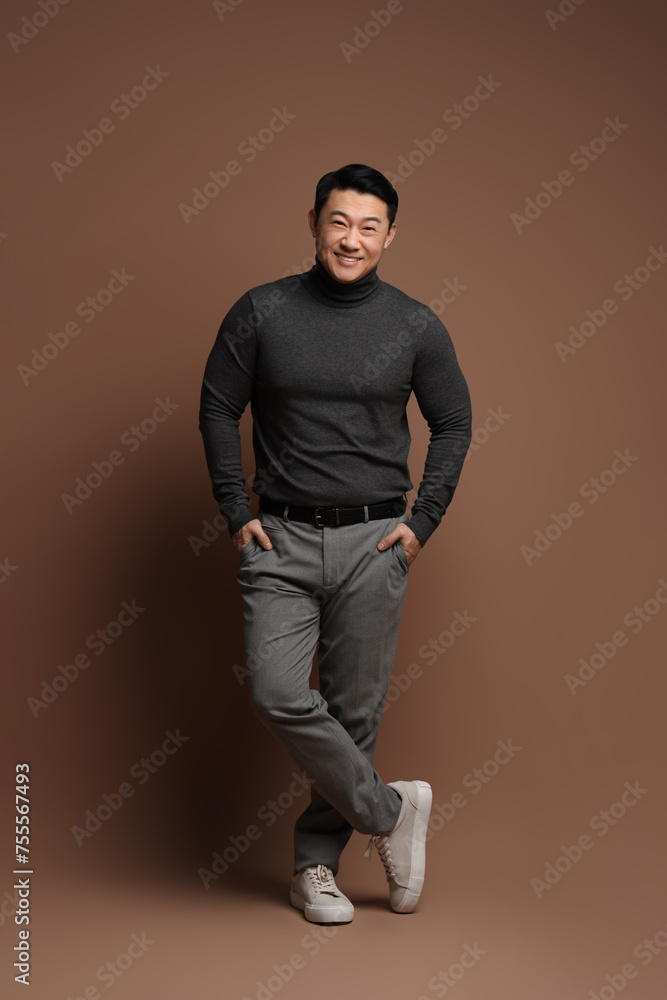 Full length portrait of happy man on brown background Full length portrait of happy man on brown background