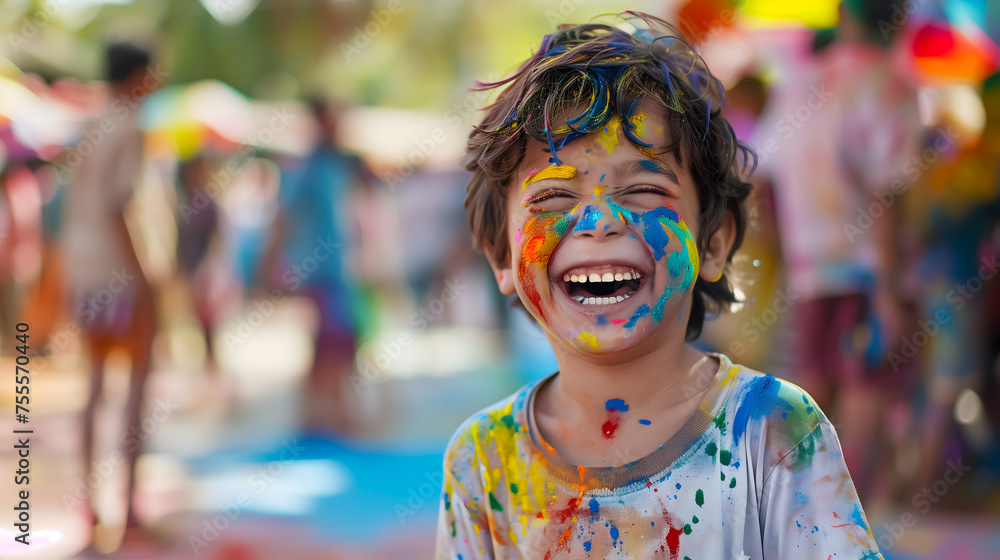 Happy laughing boy with colorful holi paint on his face Happy laughing boy with colorful holi paint on his face