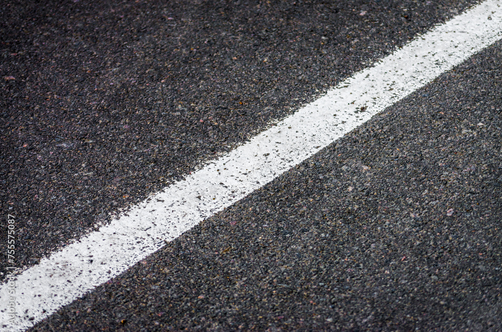 Fototapeta premium white streak of paint on gray asphalt