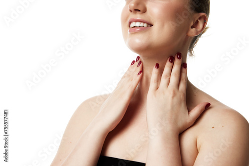 Cropped portrait of woman with radiant smile touching her neck showing effective skincare against white studio background. Concept of natural beauty people, injections, spa procedures, cosmetology. Ad