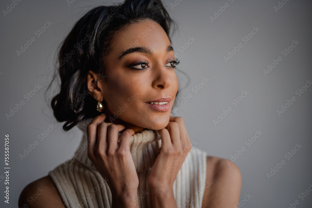 Close-up of an attractive african american woman portrait against grey wall Close-up of an attractive african american woman portrait against grey wall