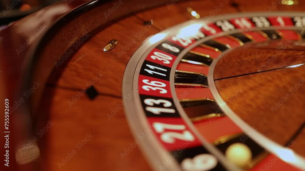 Red color casino roulette, poker game. roulette wheel. Casino theme, betting, online casino, bets, winnings. wooden casino roulette wheel with ball. Luxury casino roulette. close-up video Red color casino roulette, poker game. roulette wheel. Casino theme, betting, online casino, bets, winnings. wooden casino roulette wheel with ball. Luxury casino roulette. close-up video