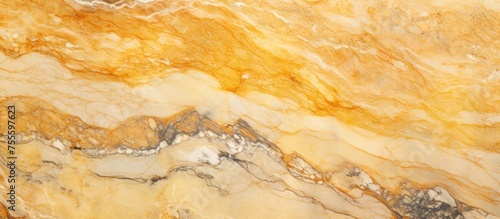A detailed view of a yellow marble surface, showcasing intricate patterns and textures. The marble appears polished, with a glossy finish reflecting light. The surface is smooth and uniform, ideal for