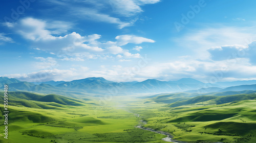 Paysage d'une prairie avec de l'herbe verte, des montagnes en arrière-plan et un beau ciel bleu avec nuages. Fond d'écran, décor, paysage calme. Pour conception et création graphique. photo