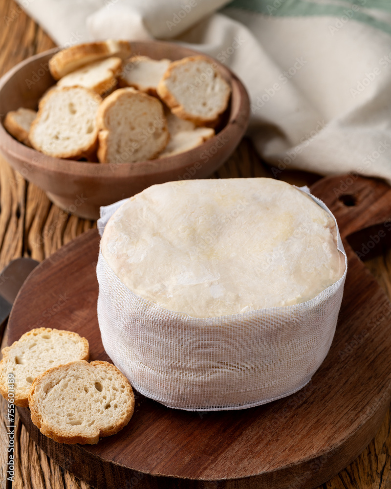 Jordao cheese, brazilian country cream cheese with toasts over wooden table Jordao cheese, brazilian country cream cheese with toasts over wooden table