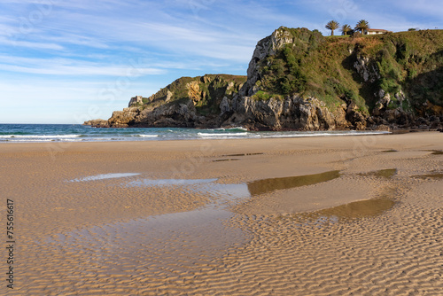 Amio beach with the cliffs and rock formations at sunset in Cantabria, Spain photo