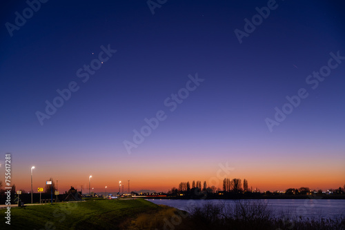 Jupiter and Saturn planets in the night sky appearing as a rare phenomenon at dusk during winter. The Great Conjunction an amazing and historical astronomical event at the end of day in Holland