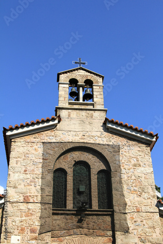 Vertical shot of an ancient church with a tower and two bells atop in Athens, Greece