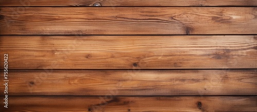 A room with a wooden wall and a brown wooden floor. The wall has a textured appearance while the floor adds warmth to the space. The combination creates a cozy and rustic atmosphere.