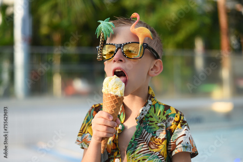 Boy eating ice cream in the pool