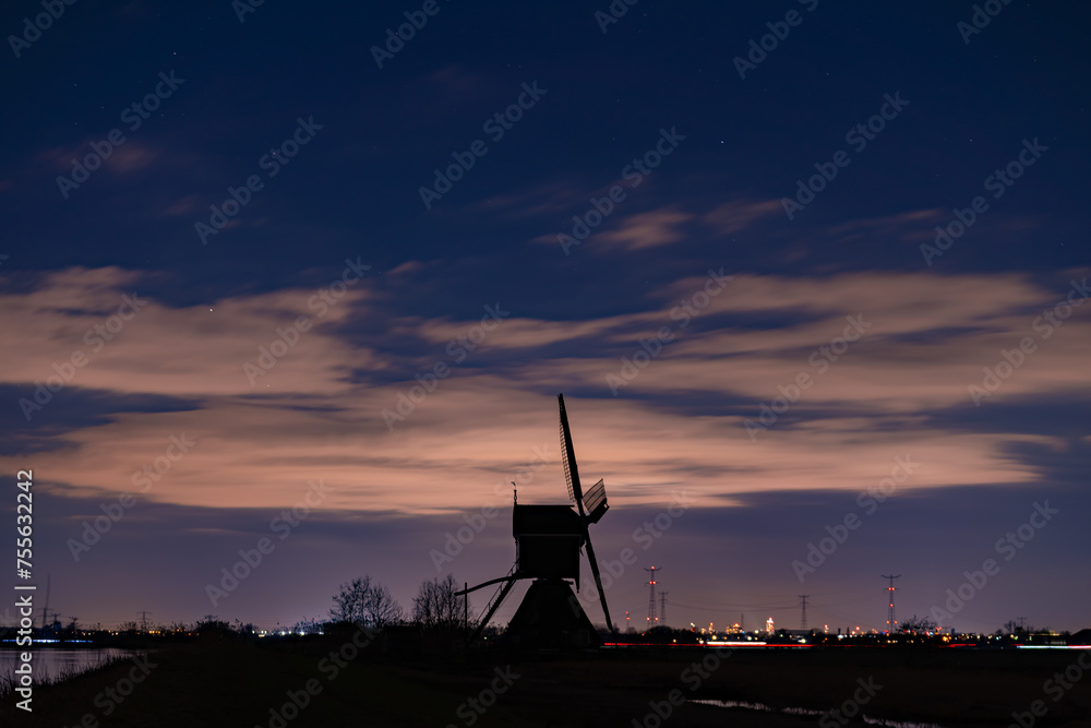 The Great Conjunction an amazing and historical astronomical event observed from the Netherlands. Jupiter and Saturn planets in the night sky appearing over an old Dutch windmill known as Broekmolen